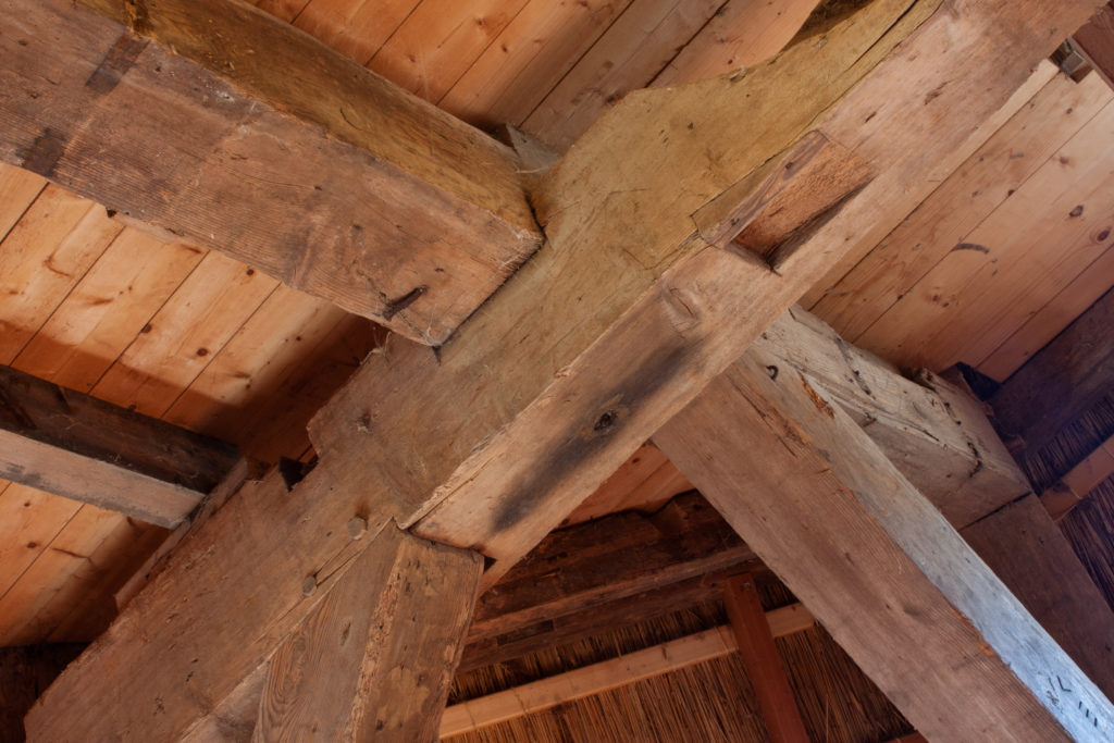 Beams of a timber frame construction home being constructed.
