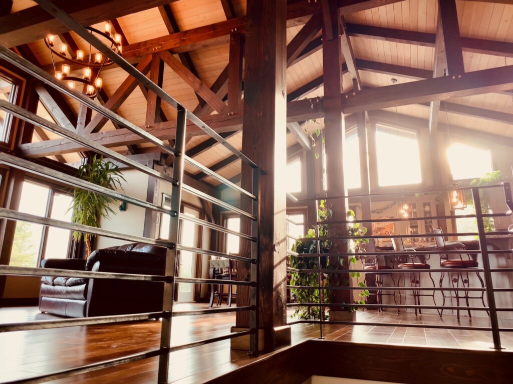 Timber frame interior with sunlit windows