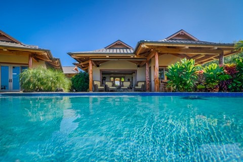 Custom Hamill Creek-crafted tropical timber frame retreat in Hawaii with large pool and ocean view