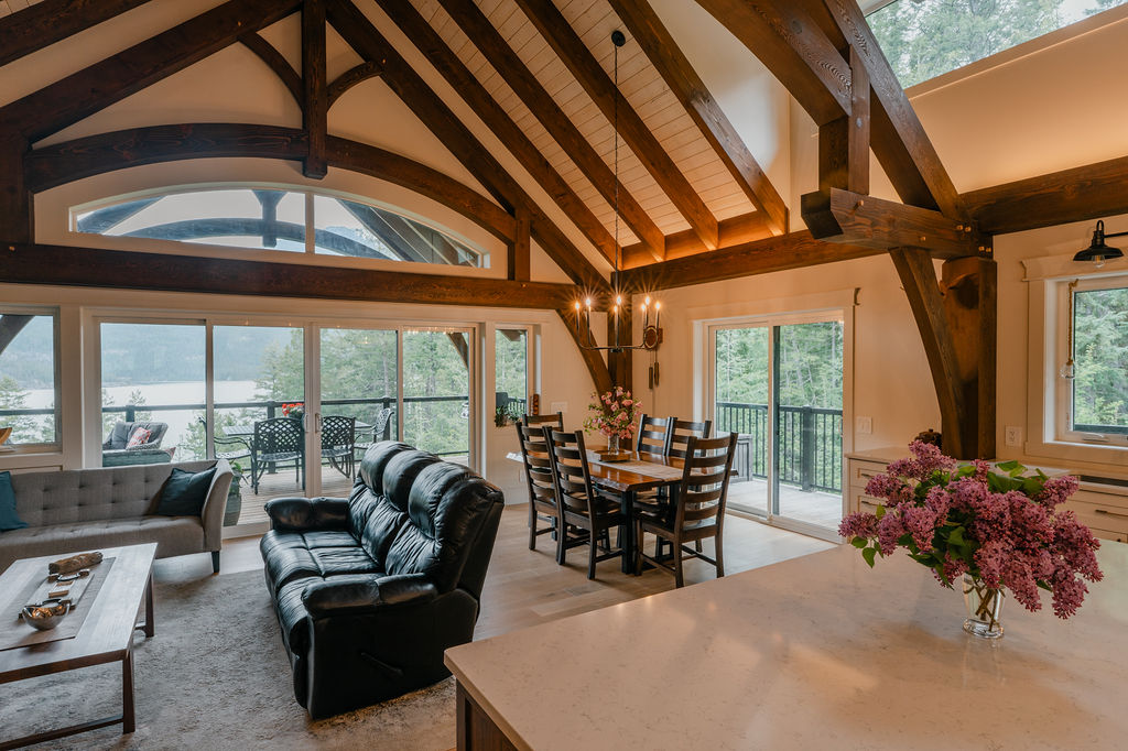 t Interior of a custom timber frame home with exposed Douglas Fir beams and vaulted ceilings built by Hamill Creek Timber Homes